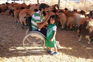 Seriously wounded in the revolt that overthrew and killed dictator Moamer Kadhafi in 2011, Osama al-Aqury uses a wheelchair as he manoeuvres easily among his animals.  By Abdullah DOMA (AFP)