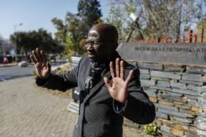 Seth Mazibuko stands along a line that points to where a young Hector Pieterson was shot down in the street during the Soweto student uprising.  By Phill Magakoe (AFP)