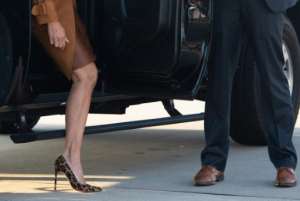 She left Washington in a safari-inspired departure outfit of suede trench coat and leopard print heels.  By SAUL LOEB (AFP/File)