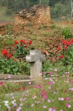 Slaughter: 2004 file picture of a mass grave and the ruins of the Notre Dame de la Visitation church in Nyange where around 2,000 Tutsis were killed.  By STR (AFP/File)
