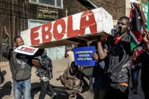 Some protesters wore protective equipment and carried a coffin with Ebola written on it.  By Luis TATO (AFP)