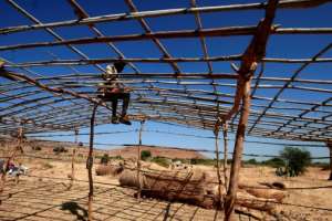 Some refugees are erecting their own basic tents as workers are rushing to build acccommodation.  By Ebrahim HAMID (AFP)