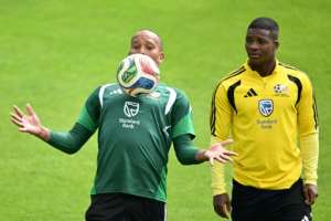 South Africa goalkeeper Ricardo Goss (L) controls the ball watched by defender Mbekezeli Mbokazi during pre-World Cup training in Mexican city Pachuca..  By YURI CORTEZ (AFP)