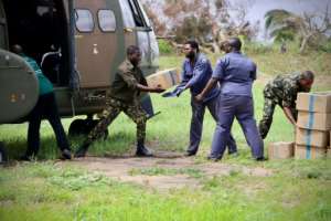 South African military personnel deliver relief aid to Buzi -- just a handful of helicopters are available for this crucial work. By ADRIEN BARBIER (AFP)