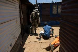 South African troops, seen in the Soul City informal settlement near Kagiso, have been deployed to round up illegal mining gangs, known as zama zamas.  By WIKUS DE WET (AFP/File)