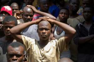 Stand and be counted: roll call at Kemena prison. The jail was built in 1826 during the British empire -- it accommodates four times its regulation capacity.  By Saidu BAH (AFP)