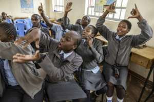 Students engaged excitedly with questions on a bionic arm, which may help to teach pupils like them STEM subjects.  By SIMON MAINA (AFP)