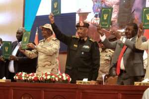 Sudan army chief Abdel Fattah al-Burhan (C R) and RSF commander Mohamed Hamdan Daglo (C L) appear on stage together in 2022, before their alliance ruptured.  By ASHRAF SHAZLY (AFP)