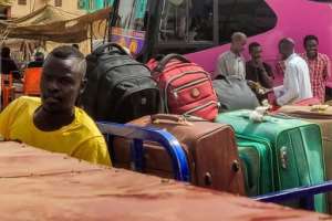 Sudanese people fleeing the violence prepare to depart on buses from al-Sittin road in the south of Khartoum on May 30, 2023.  By - (AFP)