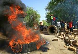 Sudanese protesters block one of Khartoum's main thoroughfares, Nile Street, with burning tyres as they keep up their campaign for civilian rule. By ASHRAF SHAZLY (AFP)