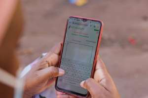 Tech support: A woman uses a dictionary app to help her type a message in Bambara on her smartphone.  By - (AFP)