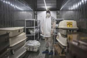 The 12-metre metal containers can store up to 40 corpses at a constant temperature of zero degrees Celsius.  By MARCO LONGARI (AFP)