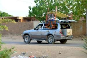 The exodus continues -- people flee with their belongings from Khartoums twin city of Omdurman.  By - (AFP)