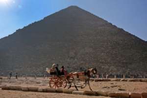 The Giza pyramids remain popular for more traditional tourism too: here people ride in a horse-drawn cart past the ancient Egyptian king Khufus Great Pyramid.  By Amir MAKAR (AFP)
