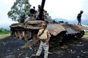 The remains of a tank that had belonged to M23 rebel soldiers, seen in October 2013, a day after Congolese army troops captured the last rebel stronghold