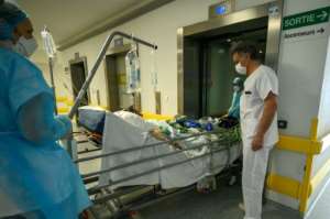 The World Health Organization has warned that the coronavirus may never fade away -- here, a French patient infected with COVID-19 is transferred back to intensive care in a Mulhouse hospital after his condition worsened.  By PATRICK HERTZOG (AFP)