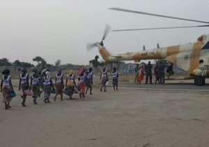 This image provided by the International Committee of the Red Cross on May 7, 2017 at a military base in Borno State shows some of the 82 rescued Chibok girls heading towards a Nigerian Army helicopter