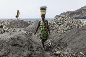 To transport sand, miners often balance heavy buckets weighing dozens of kilograms (pounds) on their heads.  By PATRICK MEINHARDT (AFP)
