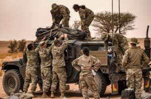 US army soldiers unload items off of a humvee (High Mobility Multipurpose Wheeled Vehicle or HMMWV) in the Grier Labouihi region in southeastern Morocco on June 9, 2021 during the African Lion military exercise.  By FADEL SENNA (AFP)
