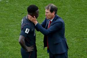 US forward Folarin Balogun is consoled by Belgium coach Rudi Garcia after the last-16 match in Seattle.  By David Ramos (GETTY IMAGES NORTH AMERICA/AFP)