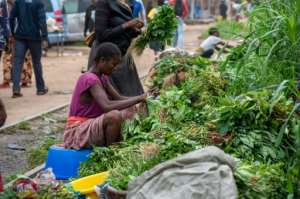 Vendors sell vegetables at the local market.  By Hardy BOPE (AFP)