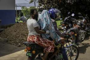 With no ambulances available, the sick get by using motorbikes to reach hospital.  By Glody MURHABAZI (AFP)