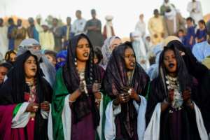 Women sing and beat the tambourine, adorned with glittering jewellery and henna tattoos.  By - (AFP)
