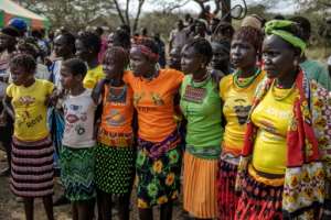 Women wear traditional attire as the community celebrates the arrival of the giraffes.  By LUIS TATO (AFP)