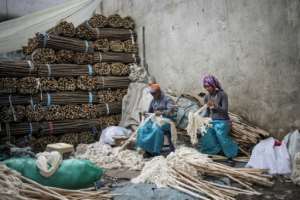 Workers make mops in a street near the Merkato district of Addis Ababa.  By Michele Spatari (AFP)
