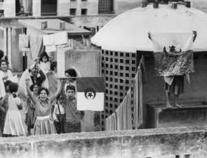 Young Algerians celebrate the anniversary of the beginning of the war of independence on an Algiers rooftop on November 1, 1961.  By JEAN-CLAUDE COMBRISSON, STF (AFP/File)