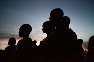 Young people from Bayanga look glued to the show on the screen in the forest clearing - a night to remember.  By FLORENT VERGNES (AFP)