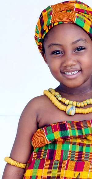An African child shows her beauty in a traditional Ghanaian outfit