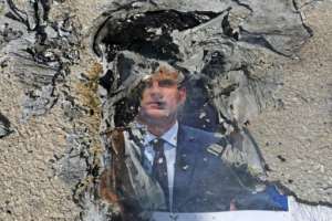 A burnt picture of French President Emmanuel Macron is seen during a demonstration against him at the Palestine Technical University near Hebron, as boycott calls on French goods grow in the Muslim world. By HAZEM BADER AFP