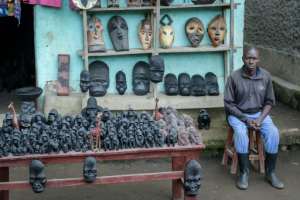 A local man displays souvenirs for sale at the entrance of Volcanoes National Park in Rwanda. By Simon MAINA AFP