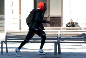 A migrant escapes running after crossing the border between Spain and France in the French Basque city of Hendaye in January 2022. By ANDER GILLENEA AFP