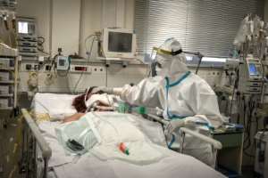 A nurse attends to a patient suffering from Covid-19 in an Athens suburb on November 20, 2020. By LOUISA GOULIAMAKI AFP