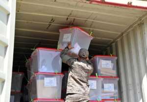 A soldier loads a truck with ballot boxes to be transported to a counting centre in the capital Tunis. By FETHI BELAID AFP