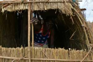 A straw hut provides the quarters for this soldier. By TONY KARUMBA AFP