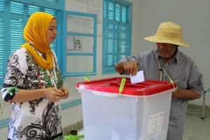 A Tunisian man votes at a polling station in Kasserine. By HATEM SALHI AFP