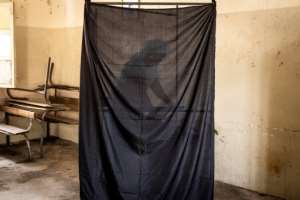 A woman chooses her voting card in Dakar on July 31. By JOHN WESSELS AFP