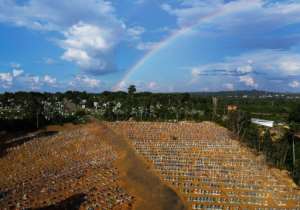 Aerial view of the burial site reserved for victims of the Covid pandemic with a rainbow in the sky at the Nossa Senhora Aparecida cemetery in Manaus, in the Amazon forest in Brazil. By MICHAEL DANTAS AFP