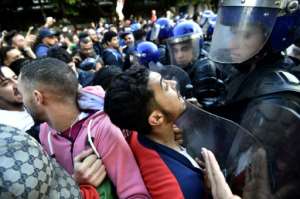 Algerian protesters scuffled with security forces during an anti-government demonstration in the capital Algiers on the eve of the election. By RYAD KRAMDI AFP