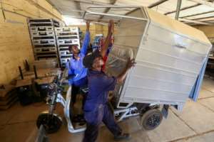 An electric vehicle is put together in the factory, which says the machines are more efficient and cheaper than regular fuel-powered engines. By ASHRAF SHAZLY AFP