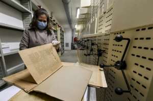 An employee at the National Library of Tunisia leafs through old newspapers. By Fethi Belaid AFP
