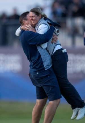 Ashleigh Buhai gets a warm embrace from husband David. By Neil Hanna AFP