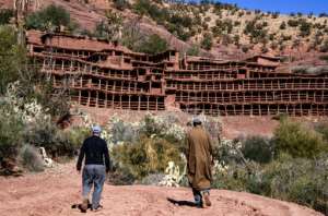 Beekepers walk towards the Inzerki apiary; experts say it is the oldest traditional, collective beehive in the world, but today it is under threat amid a changing climate. By FADEL SENNA AFP