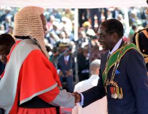 Britain's relations with Zimbabwe went downhill after Mugabe, seen here at a post-election inauguration ceremony in 2013, cracked down on dissent and seized land from white farmers. By ALEXANDER JOE AFP