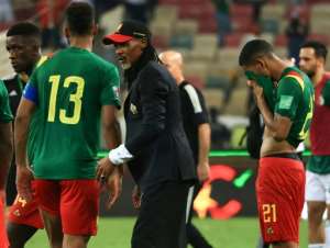 Cameroon coach Rigobert Song C consoles his players after losing to Algeria in the first leg of a World Cup play-off in Douala on March 25, 2022.. By Daniel BELOUMOU OLOMO AFP
