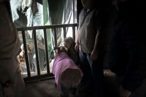Contact: Rhino calf and carer. By GUILLEM SARTORIO AFP