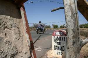 Customs officers sometimes let a driver take a motorbike taxi to the nearest Malian village to withdraw funds through a telephone transfer. By Sia KAMBOU AFP